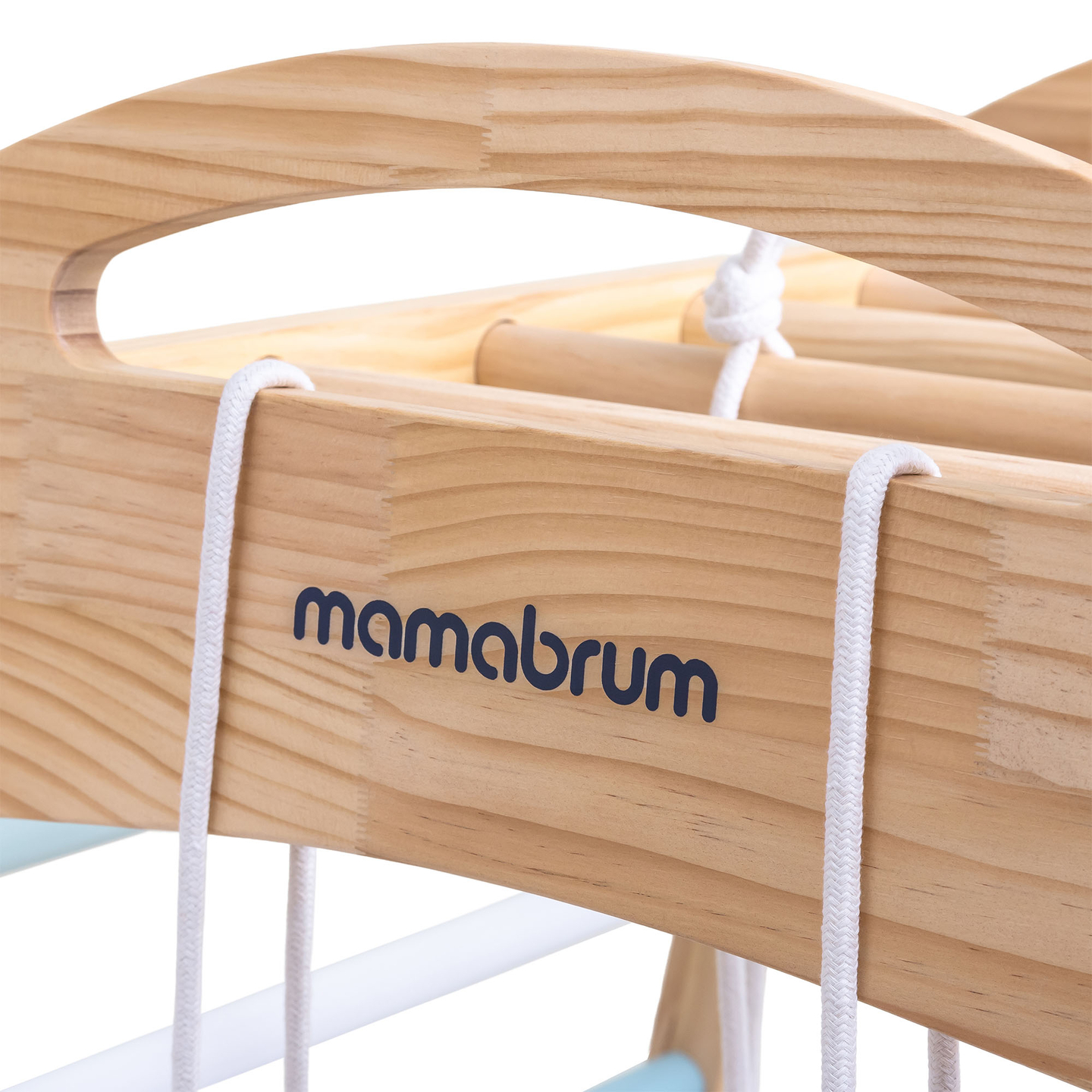 Parque infantil interior de madera con columpio, anillos de gimnasia y red de escalada.